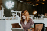 Young woman using laptop in a coffee shop