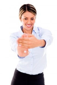 Businesswoman stretching her hand to avoid carpal tunnel syndrom