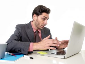 Attractive Businessman In Suit And Tie Working In Stress At Offi